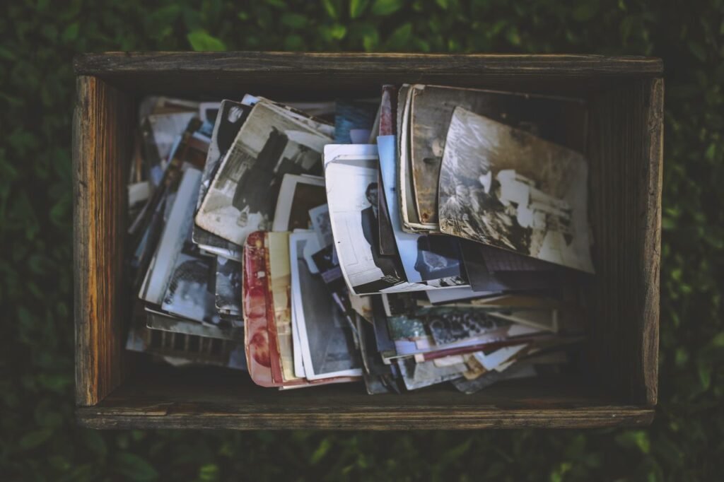 A nostalgic collection of vintage photos in an old wooden box.