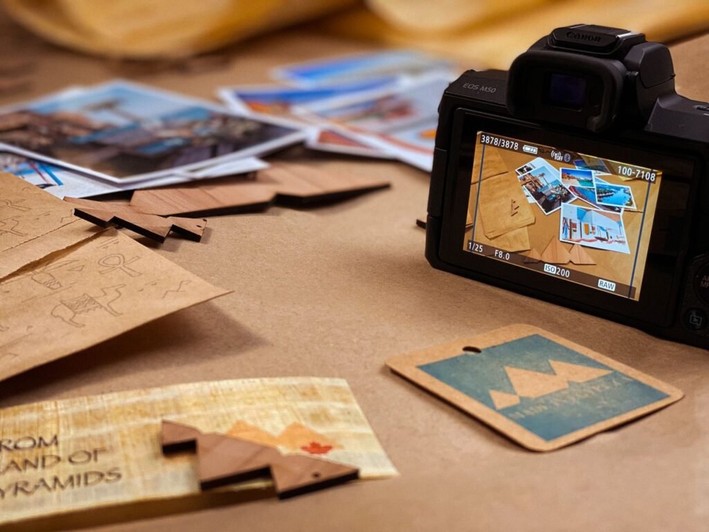Camera and printed photos arranged on a desk for creative photography exploration.