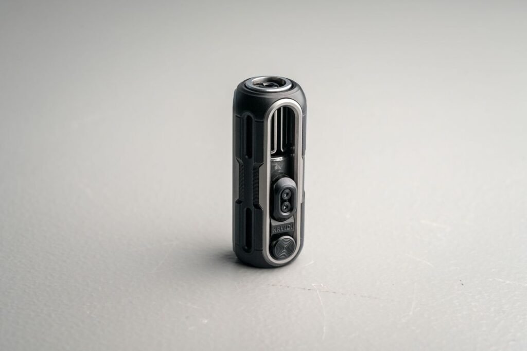 Detailed view of a sleek, compact action camera on a neutral background, showcasing its modern design.